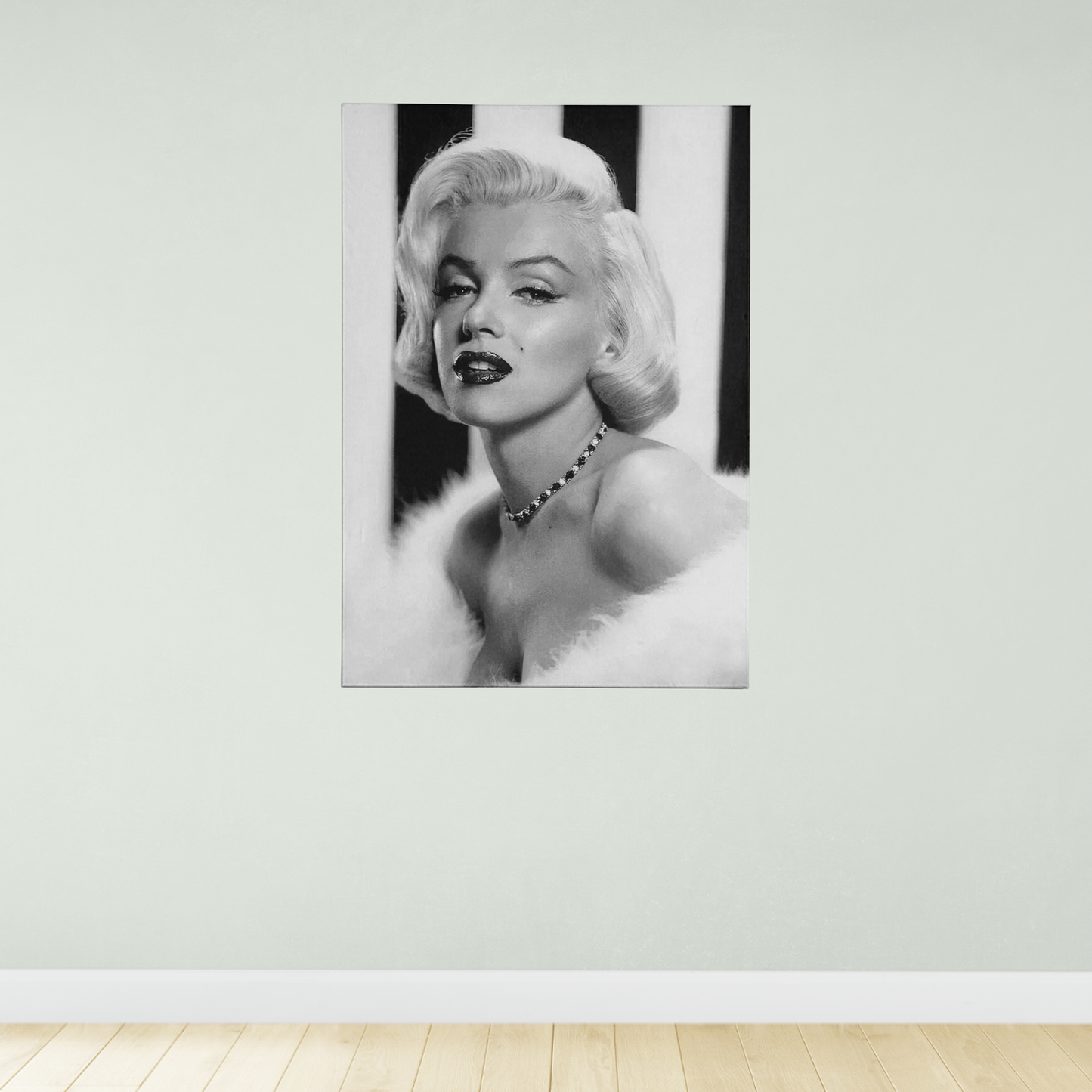 A black and white portrait of Marilyn Monroe, a famous American actress, is displayed on the wall.