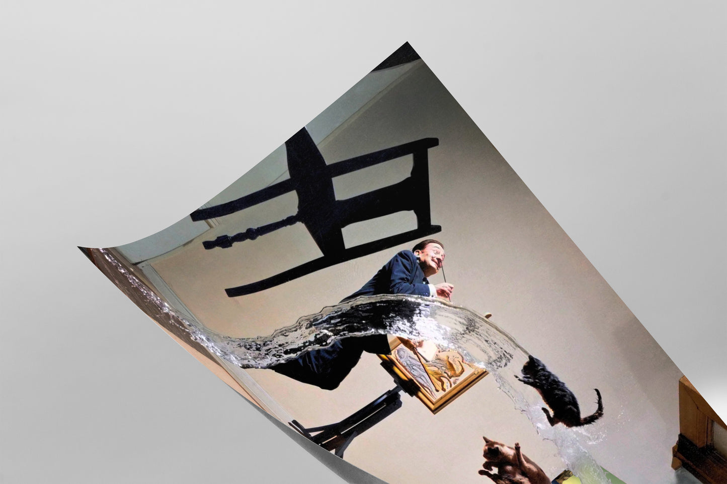 A man in a suit is captured in mid-jump, with a cat leaping out of a glass of water, creating a dynamic and playful scene.