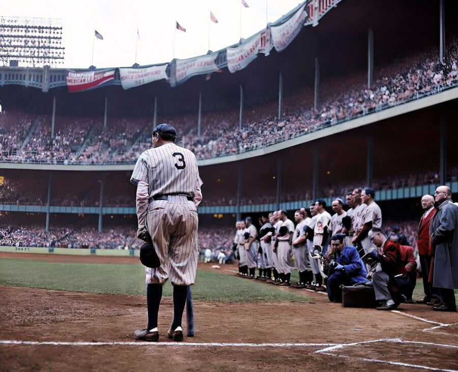 A baseball player in a striped uniform stands on the field, with a group of players and spectators visible in the background.