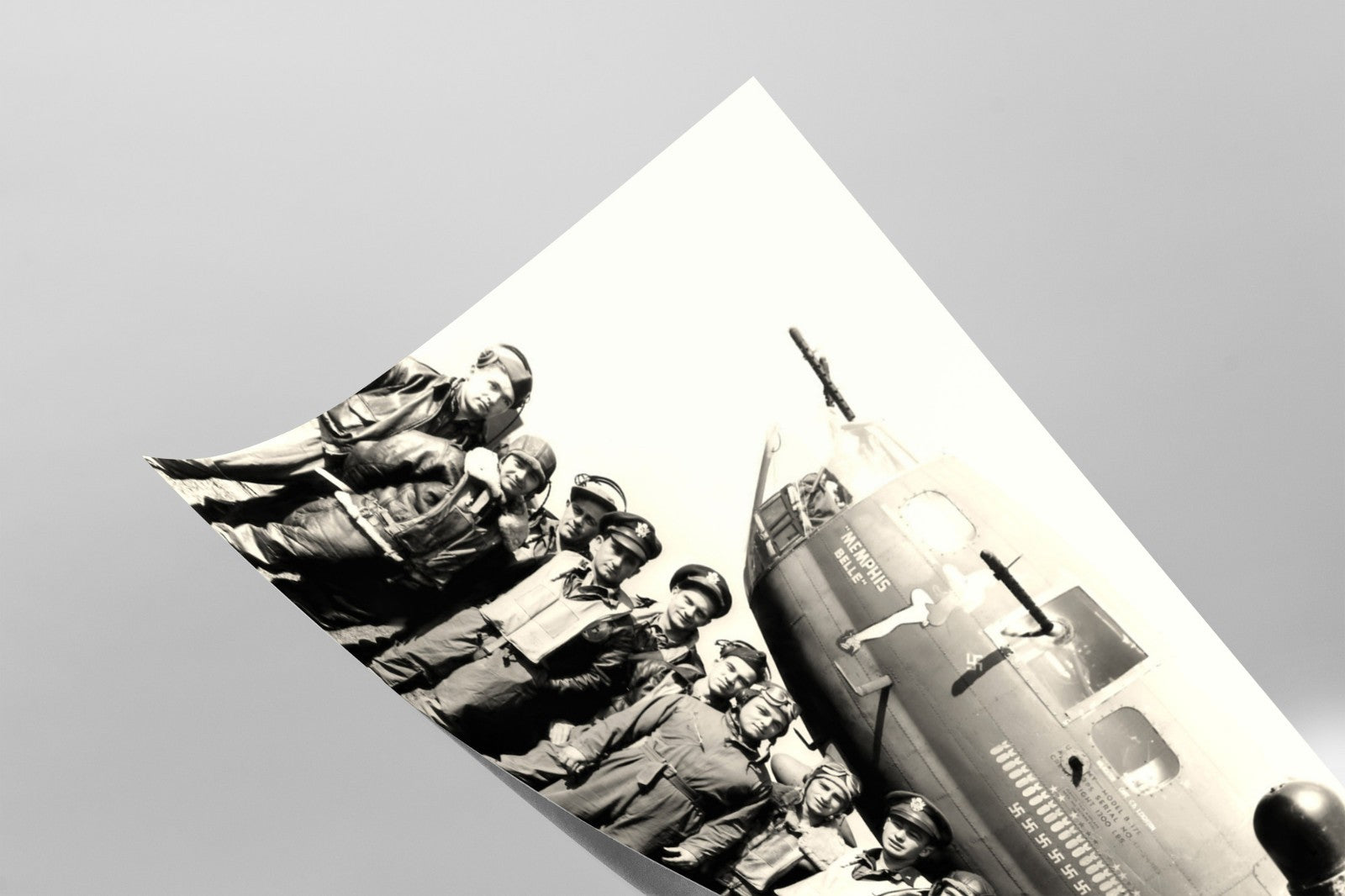 A group of men in military uniforms standing in front of a vintage military aircraft, likely from World War II.