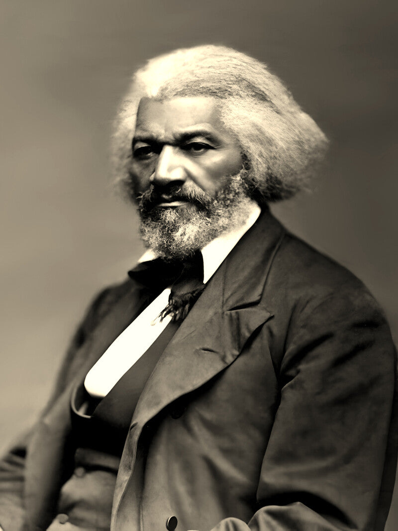 A black and white portrait of a man with a long white beard, wearing a suit and tie, looking directly at the camera with a serious expression.