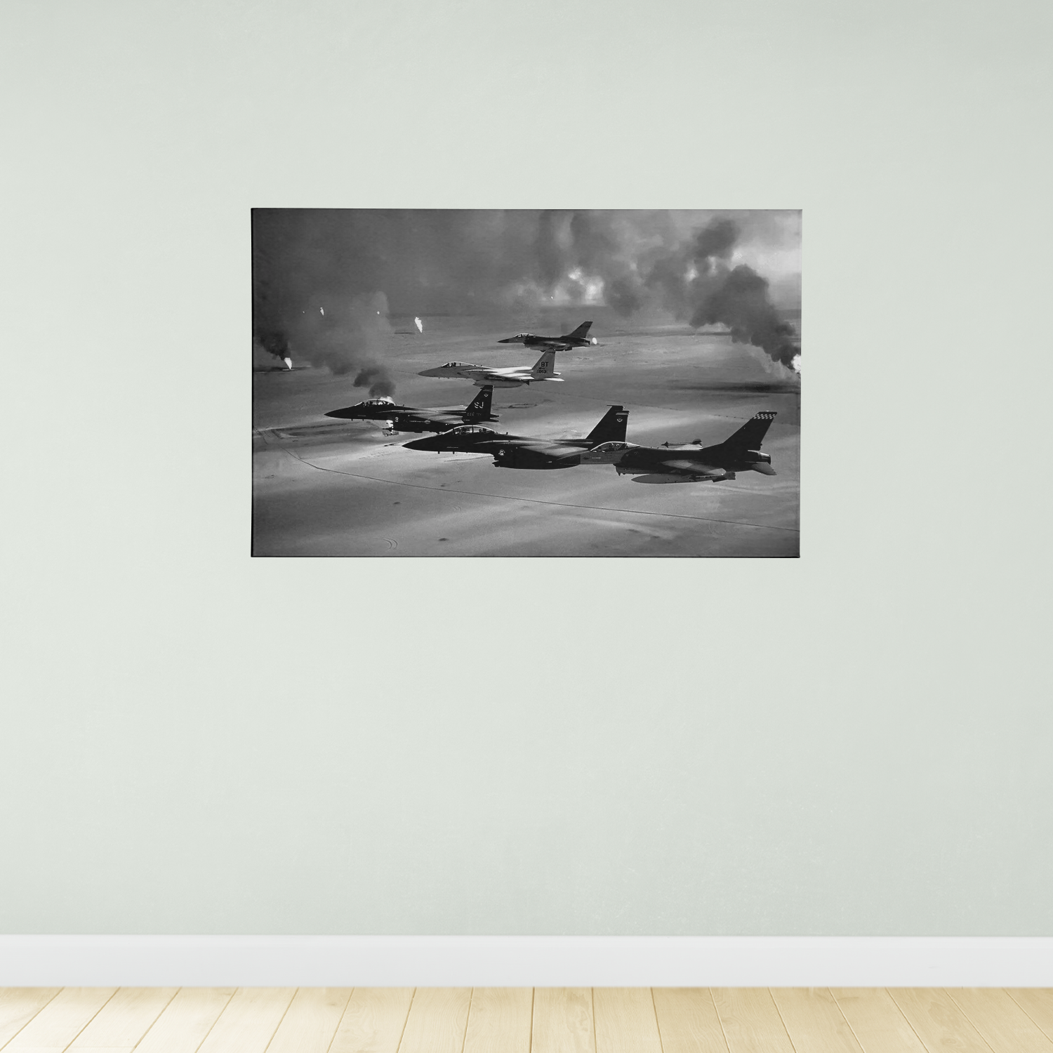 A black and white photograph of three fighter jets flying in formation against a cloudy sky.
