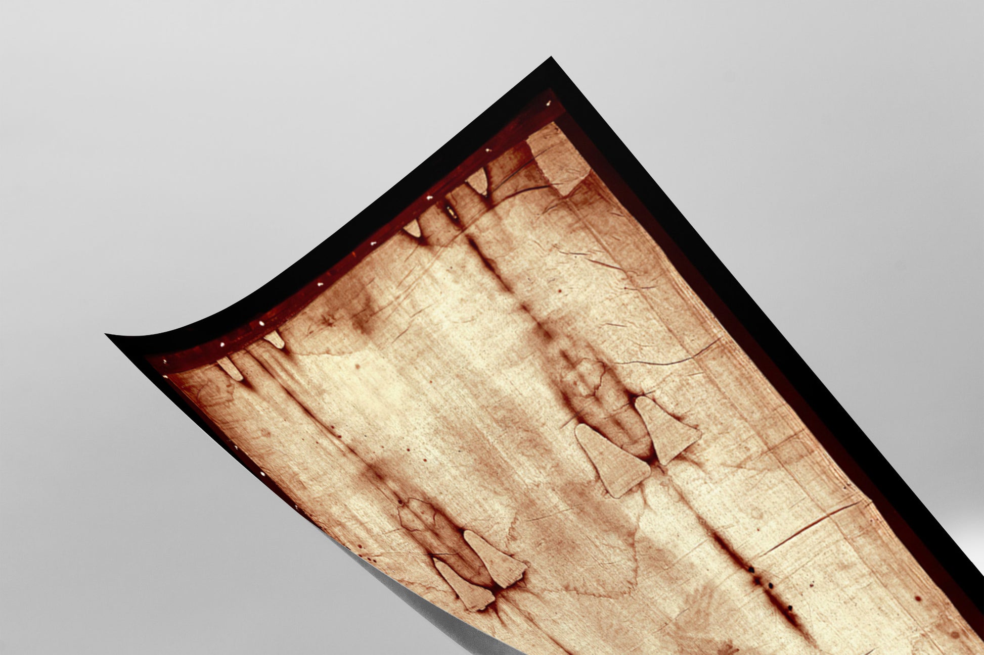 a close-up view of a piece of paper or fabric with a textured, stained appearance, possibly resembling a piece of artwork or a printed material.