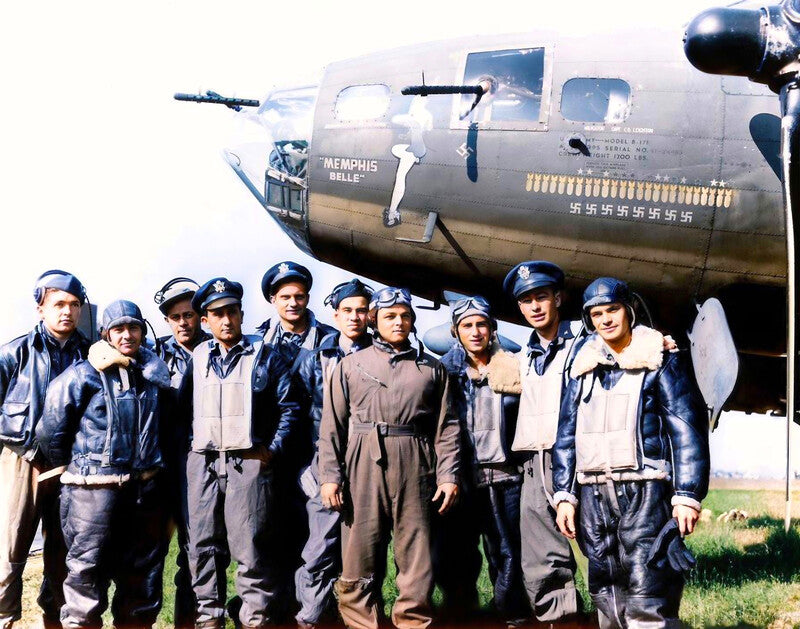 A group of men in military uniforms posing in front of a World War II-era bomber aircraft.